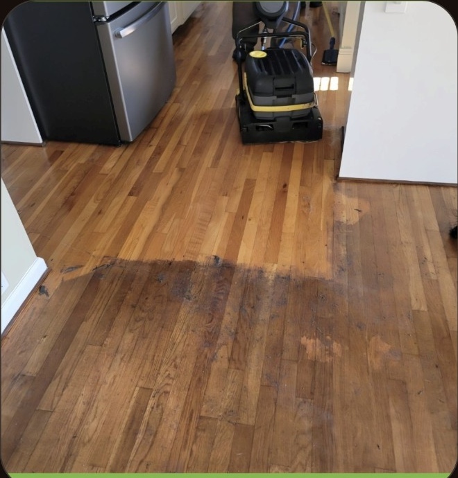 Wax and acrylic coating removal in progress on hardwood flooring