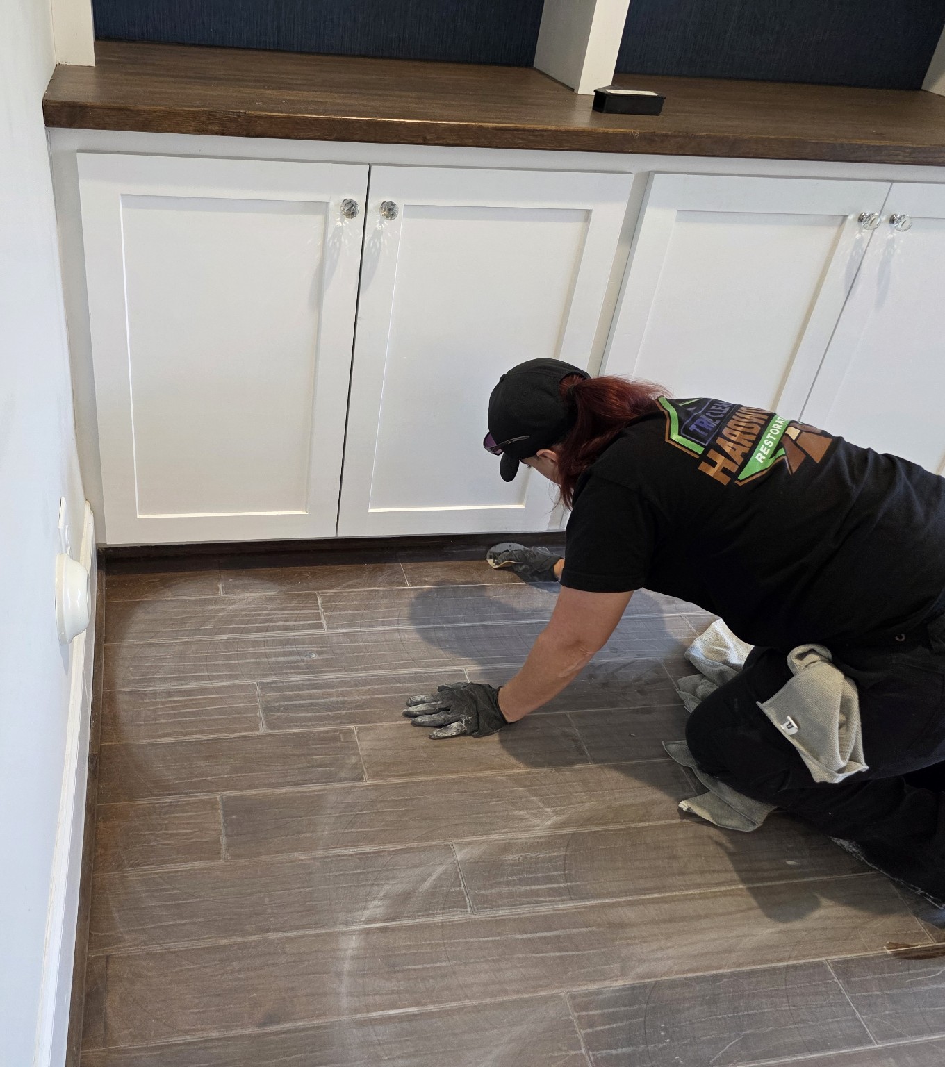 Technician hand detailing hardwood floor