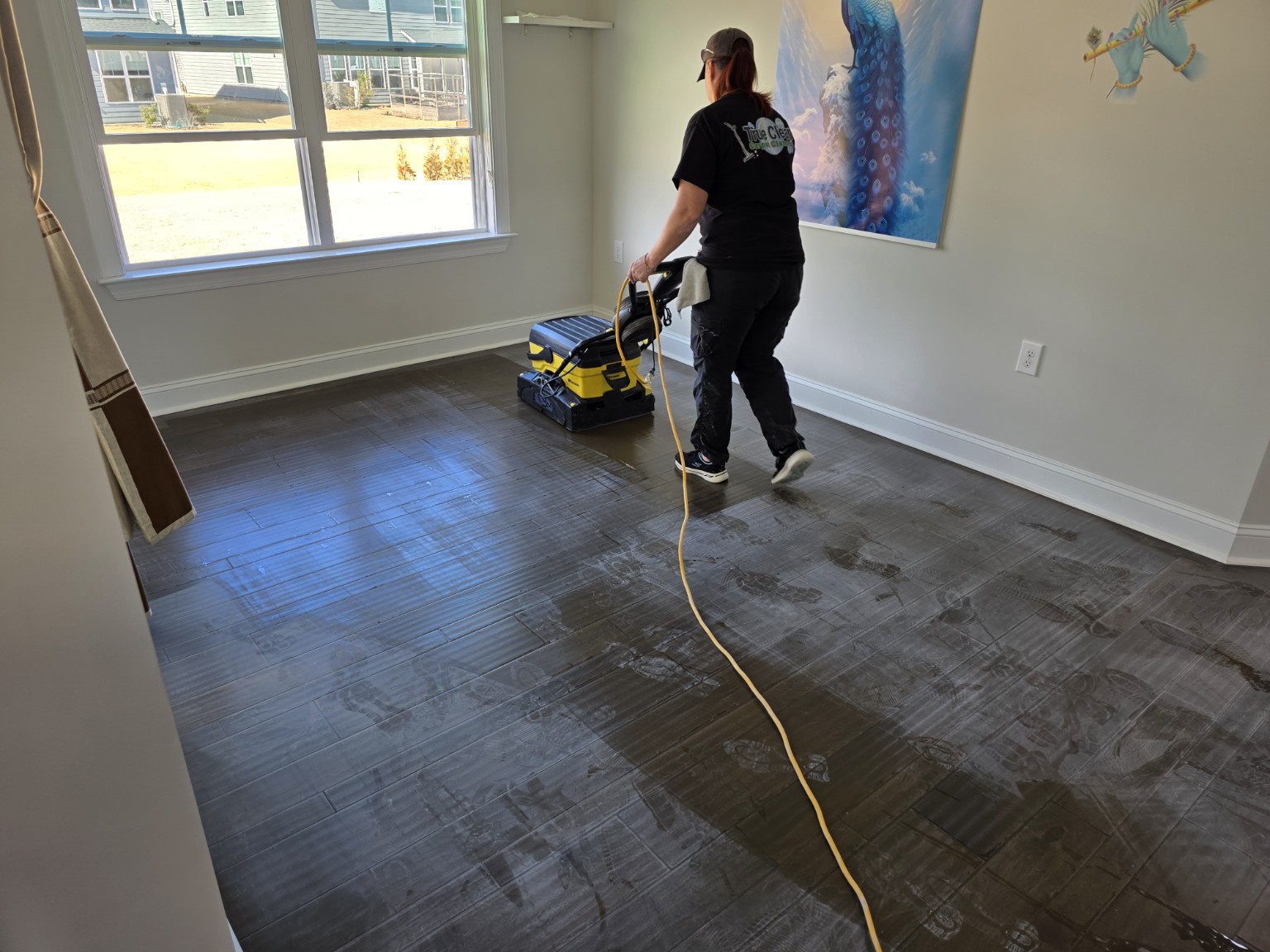 True Clean technician preparing prefinished engineered hardwood with professional equipment