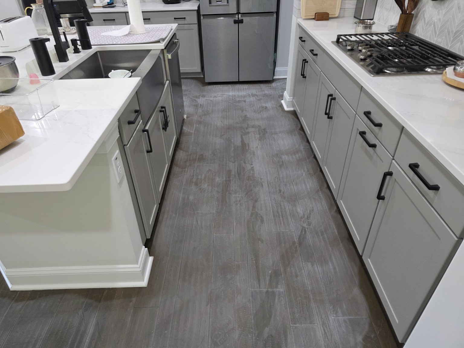 Engineered hardwood kitchen floor before restoration