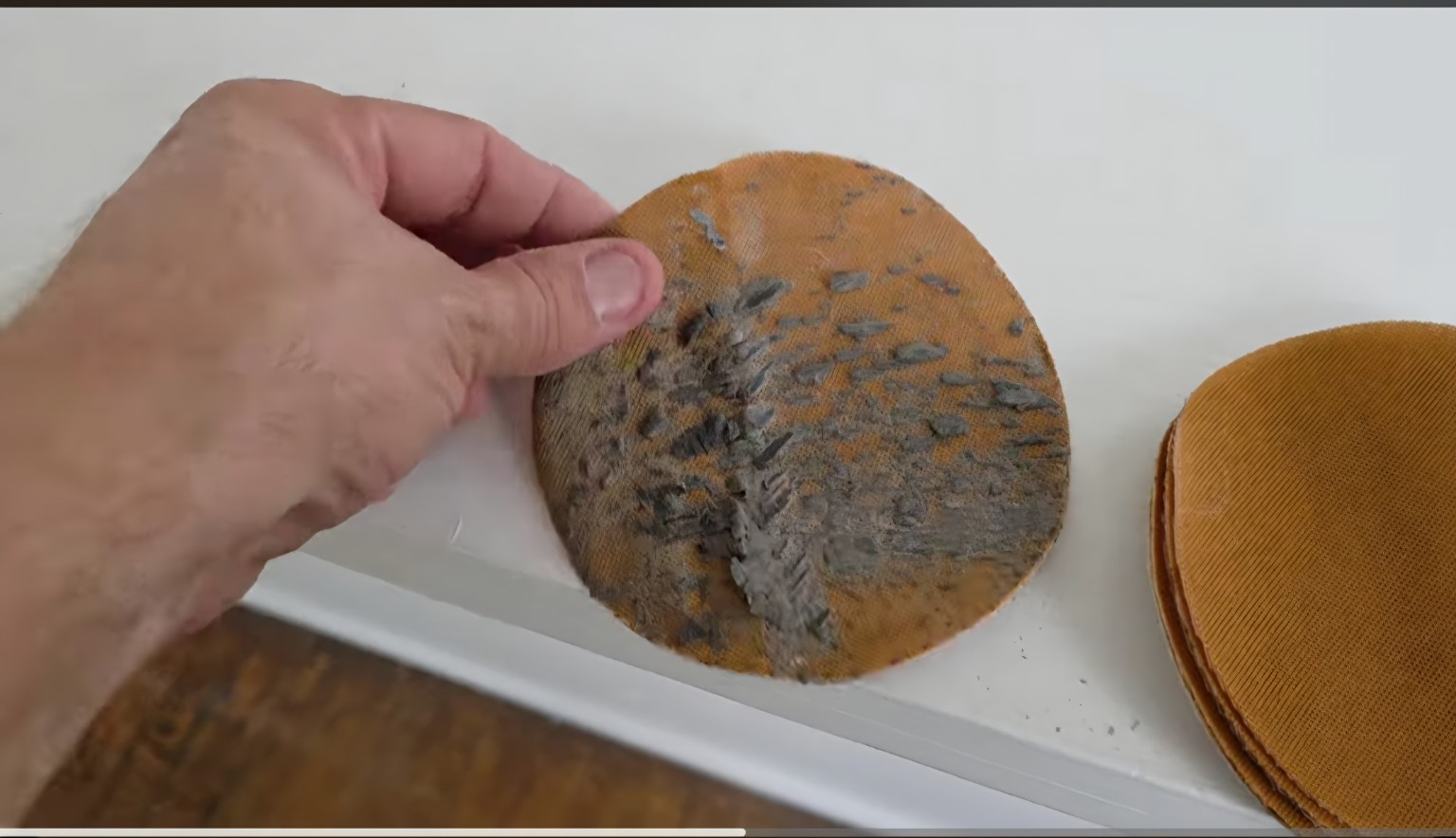 Abrasive disc showing residue removed from the historic hardwood floor