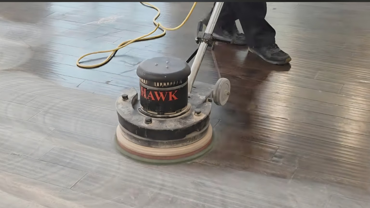 Worn hardwood floor before a screen and recoat